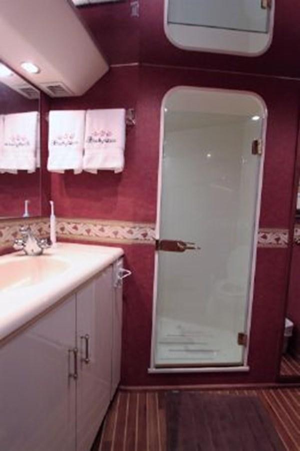 a bathroom with pink walls aboard BROKYSTONE Yacht for Sale