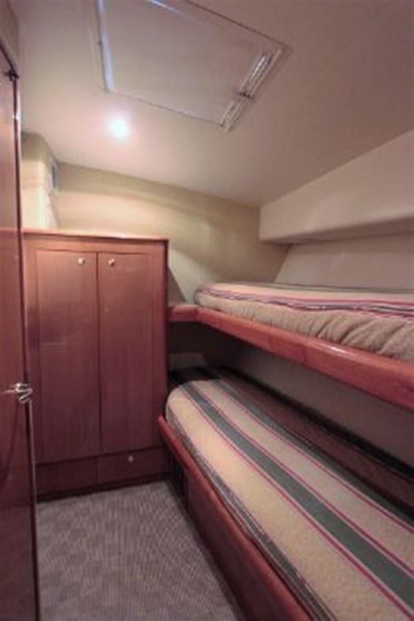 a room with a bed and a dresser aboard BROKYSTONE Yacht for Sale
