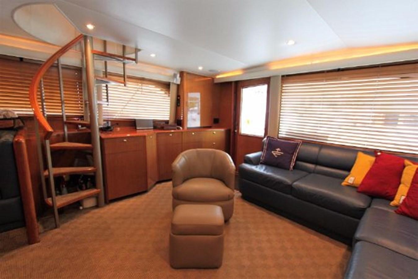 a living room with a couch and a ladder aboard BROKYSTONE Yacht for Sale
