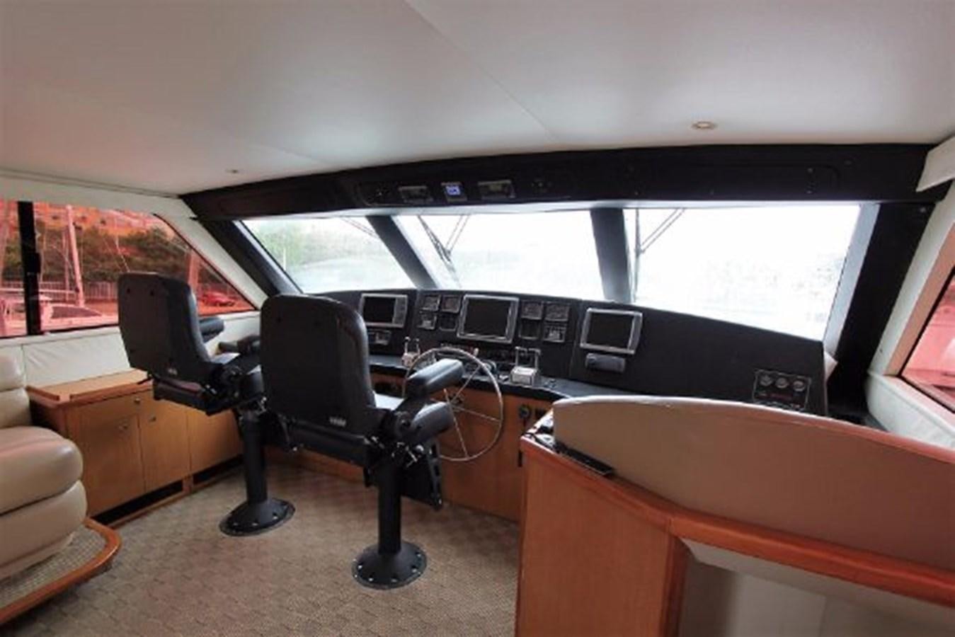 a car with a desk and a chair in it aboard BROKYSTONE Yacht for Sale