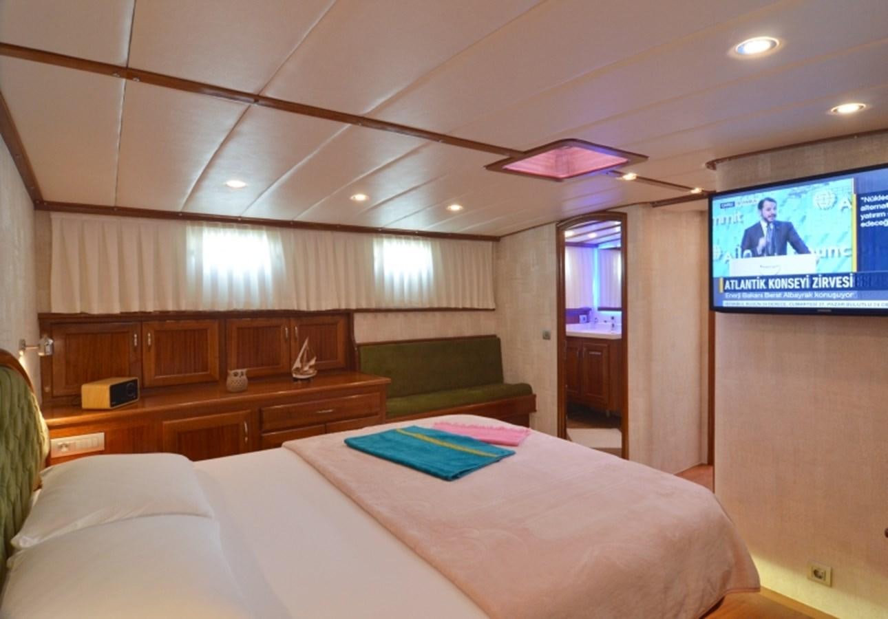 a room with a tv and a bed aboard ZORBAS Yacht for Sale