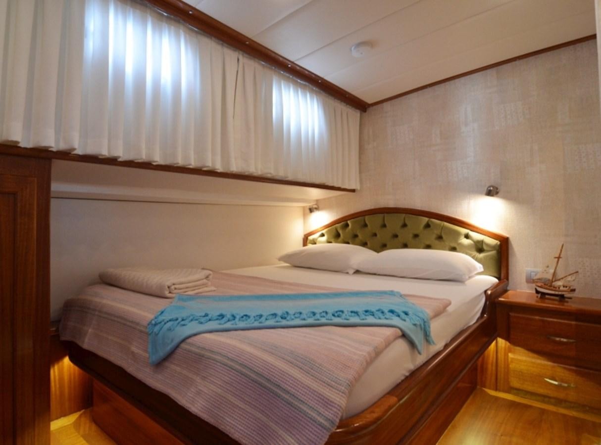 a room with a bed and a window aboard ZORBAS Yacht for Sale