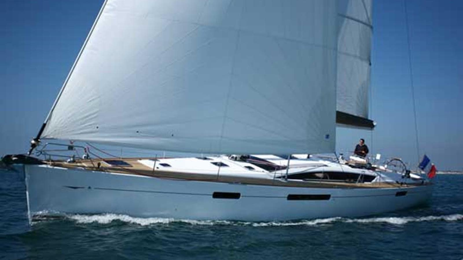 a white boat on the water aboard JEANNEAU 57 Yacht for Sale