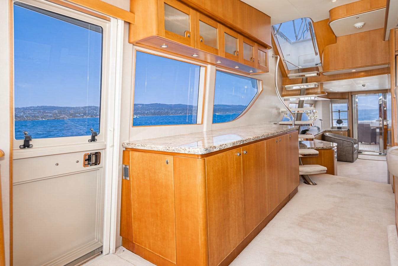 a room with a large window and wood cabinets aboard ESOTERIC Yacht for Sale