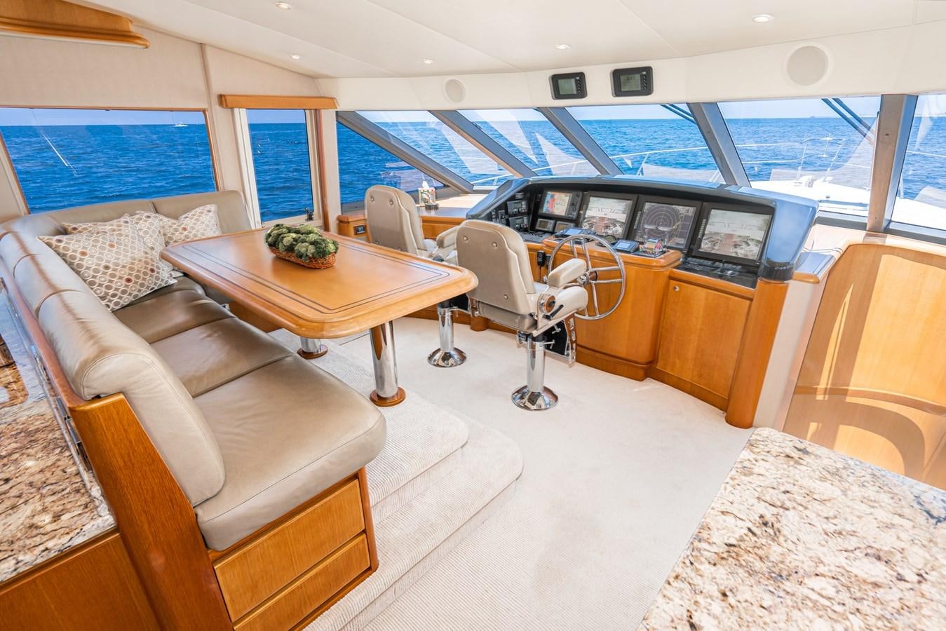 a room with a table chairs and a couch aboard ESOTERIC Yacht for Sale