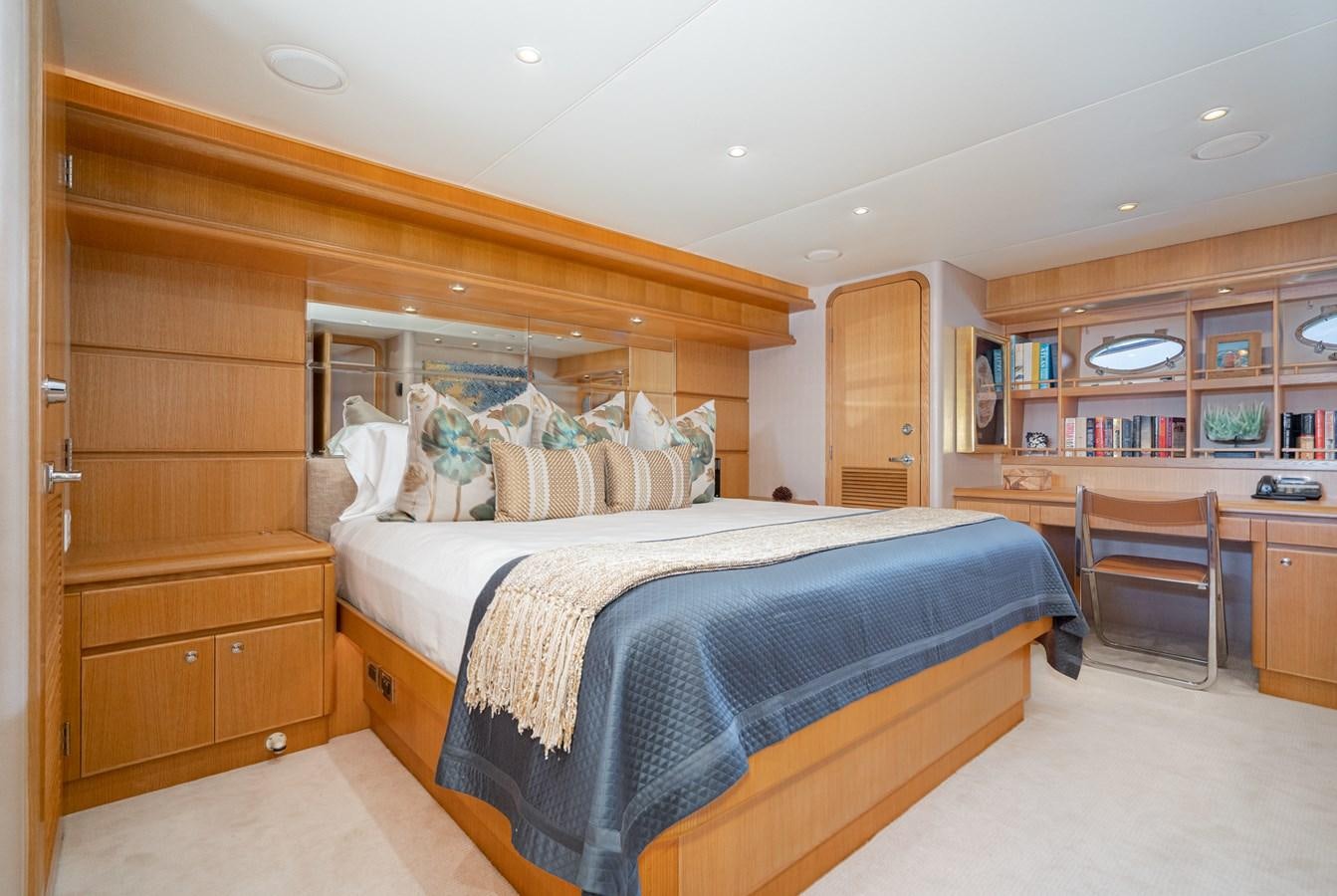 a bedroom with a bed and desk aboard ESOTERIC Yacht for Sale