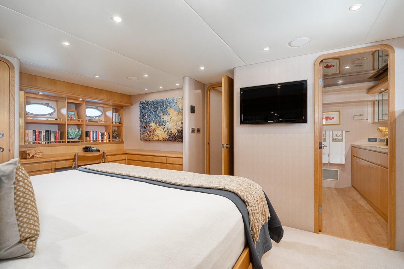 a bedroom with a bed and a television aboard ESOTERIC Yacht for Sale