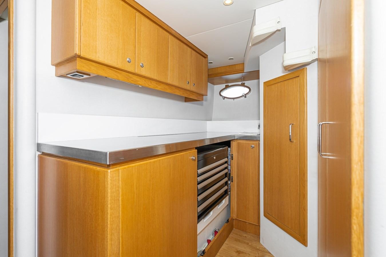 a kitchen with wooden cabinets aboard ESOTERIC Yacht for Sale