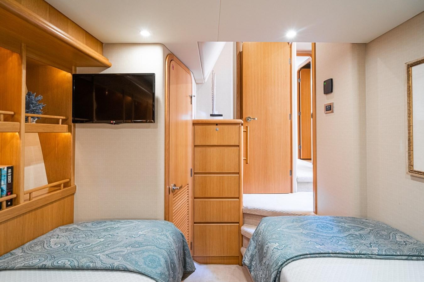 a bedroom with a bed and a television aboard ESOTERIC Yacht for Sale