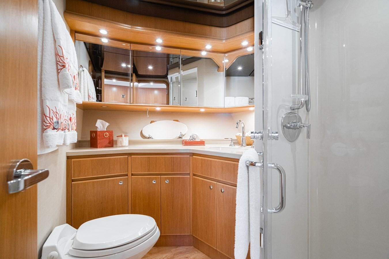 a bathroom with wooden cabinets aboard ESOTERIC Yacht for Sale