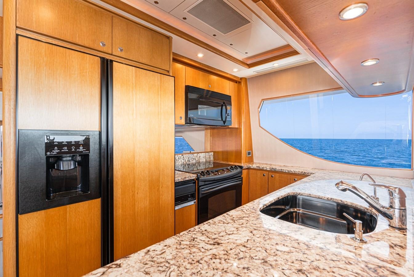 a kitchen with wooden cabinets aboard ESOTERIC Yacht for Sale