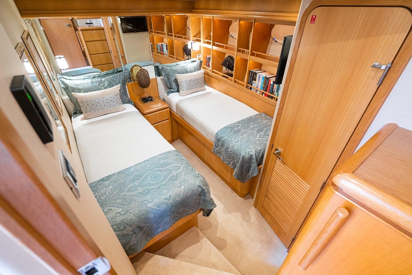 a bedroom with a bed and a desk aboard ESOTERIC Yacht for Sale