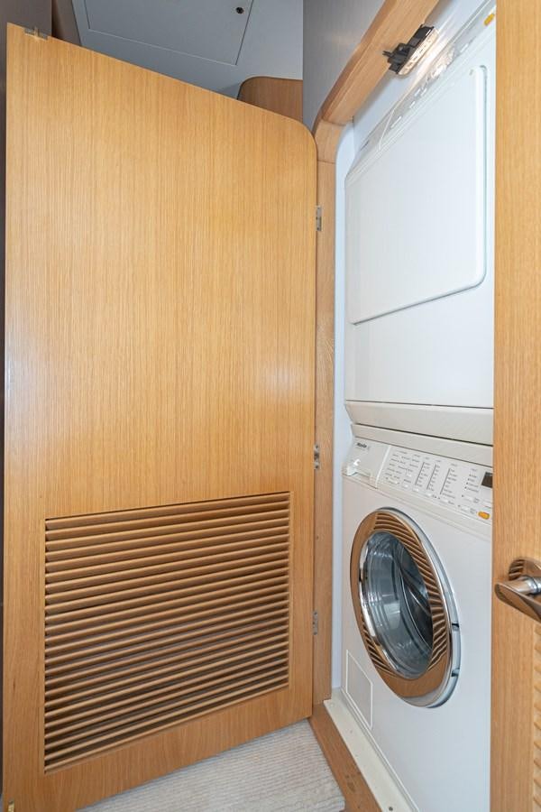 a closet with a washing machine aboard ESOTERIC Yacht for Sale