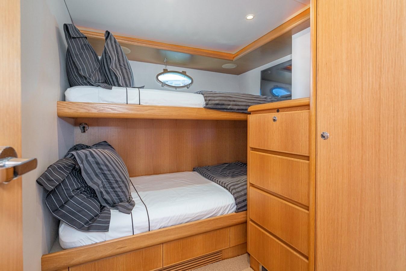 a closet with clothes and a bed aboard ESOTERIC Yacht for Sale