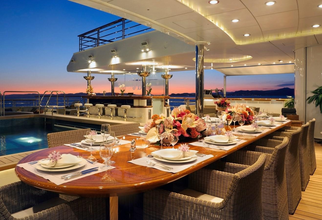 a large dining room with tables and chairs aboard OCTOPUS Yacht for Sale