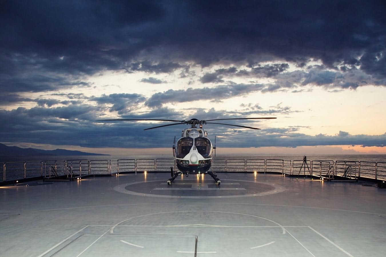 a helicopter on a runway aboard OCTOPUS Yacht for Sale