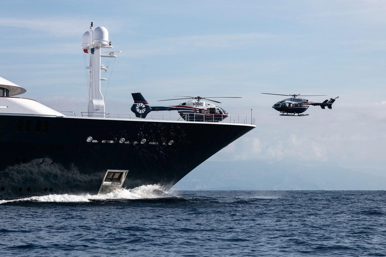 a helicopter flying over a ship aboard OCTOPUS Yacht for Sale