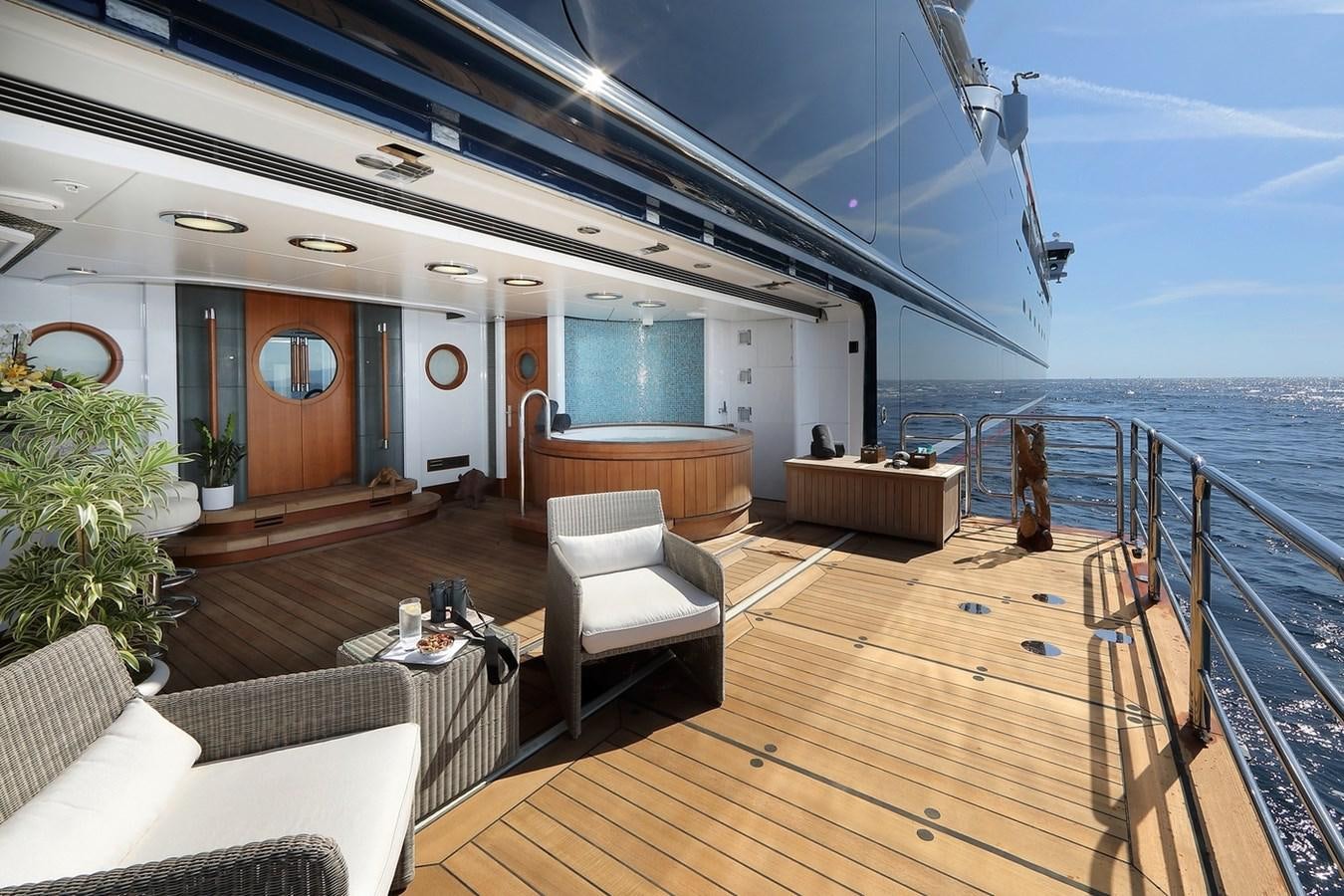 a large living room with a wood floor and a wood deck aboard OCTOPUS Yacht for Sale