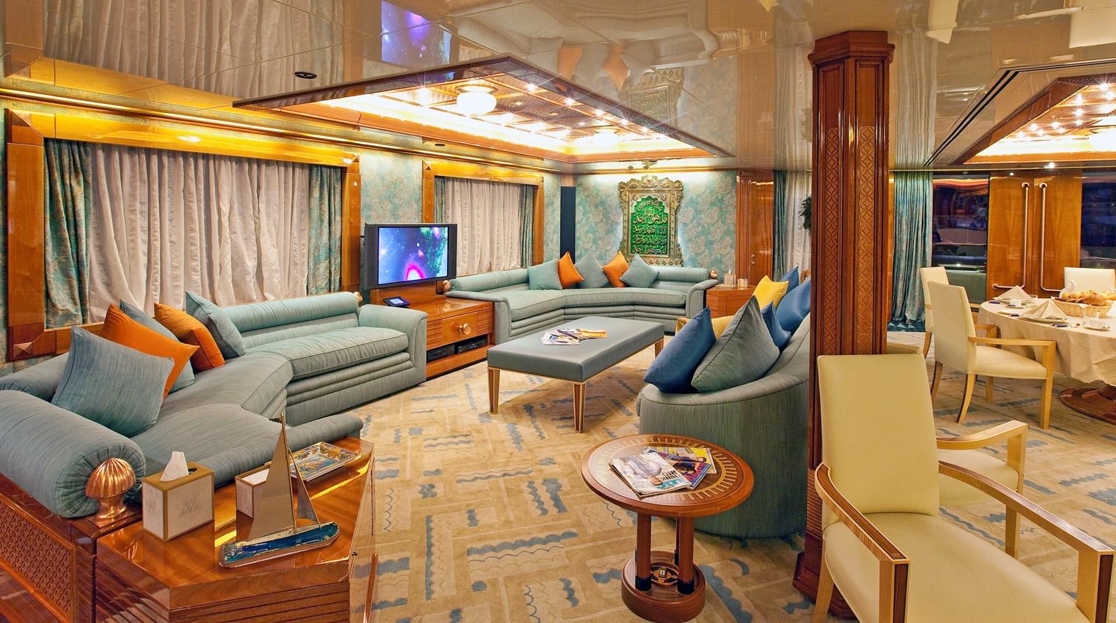 a living room with a couch and a television aboard LADY MOURA Yacht for Sale