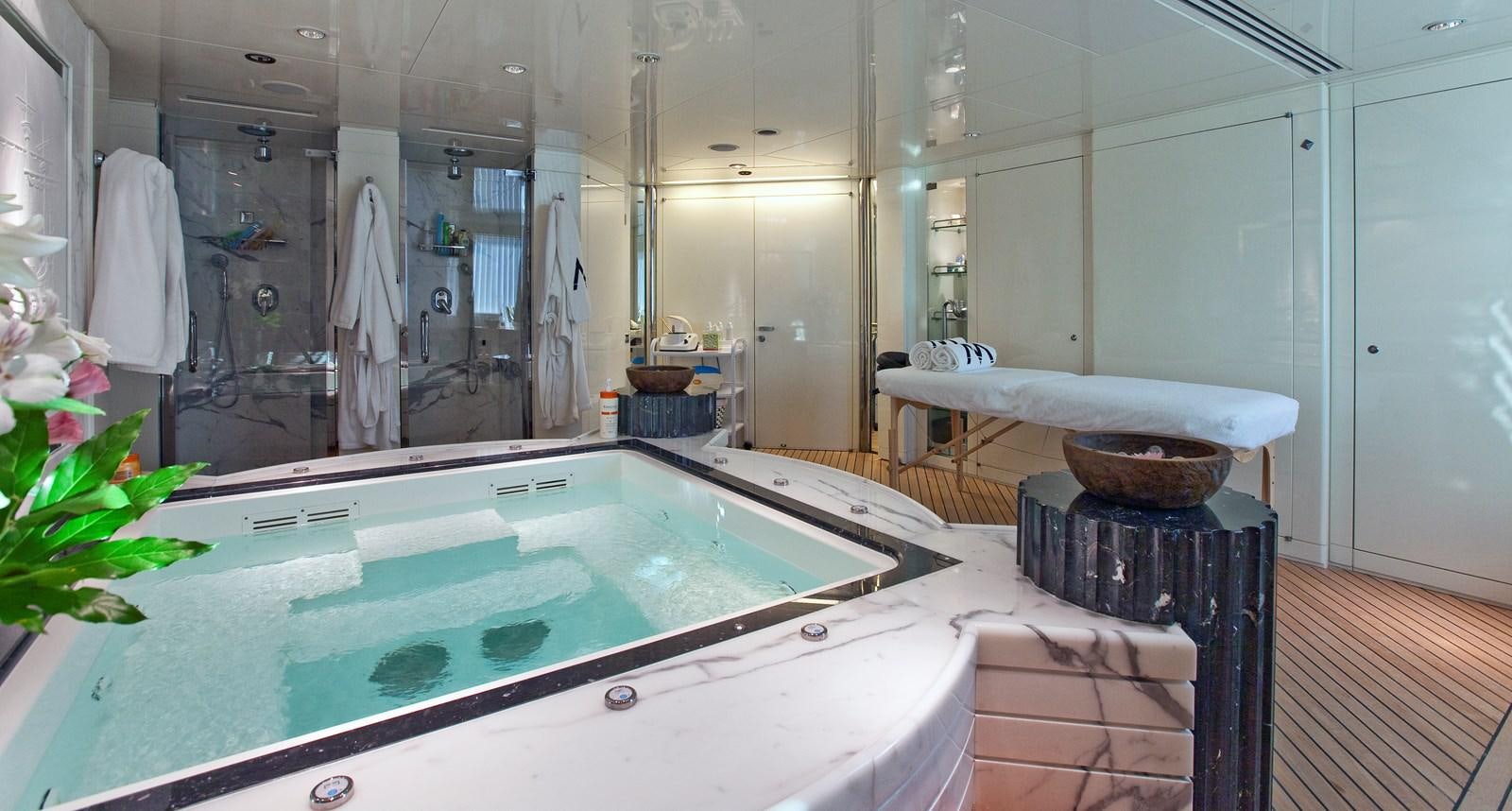 a large bathroom with a jacuzzi aboard LADY MOURA Yacht for Sale