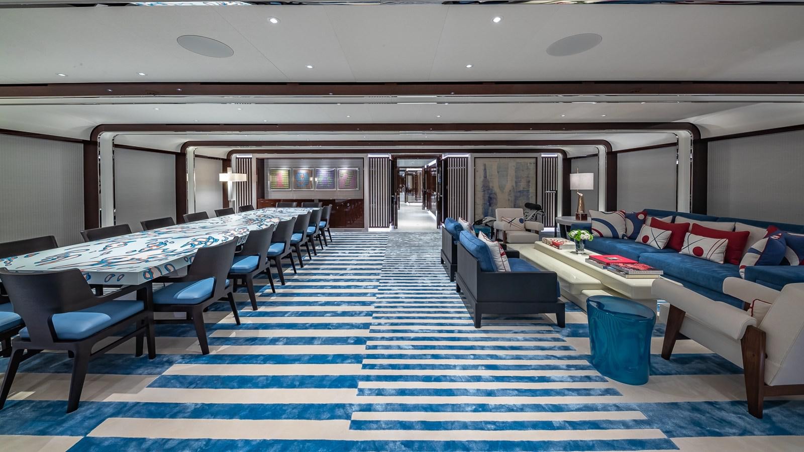 a large room with a table and chairs aboard CC-SUMMER Yacht for Sale