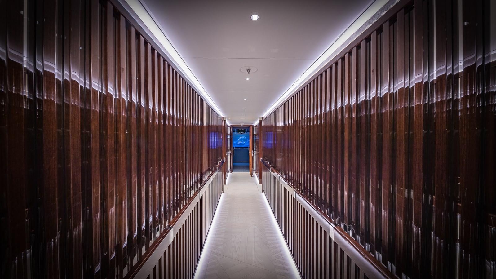 a long hallway with a row of wooden cabinets aboard CC-SUMMER Yacht for Sale