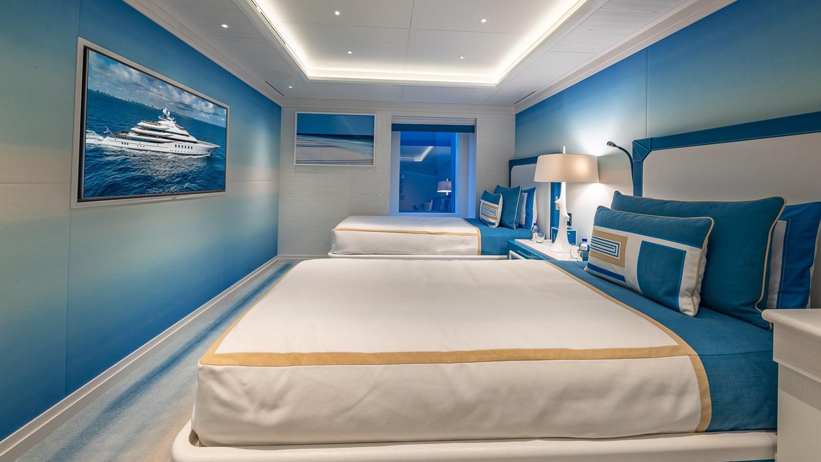 a room with a bed and a blue couch aboard CC-SUMMER Yacht for Sale