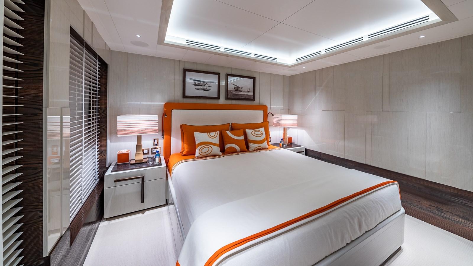 a bedroom with a bed and a desk aboard CC-SUMMER Yacht for Sale