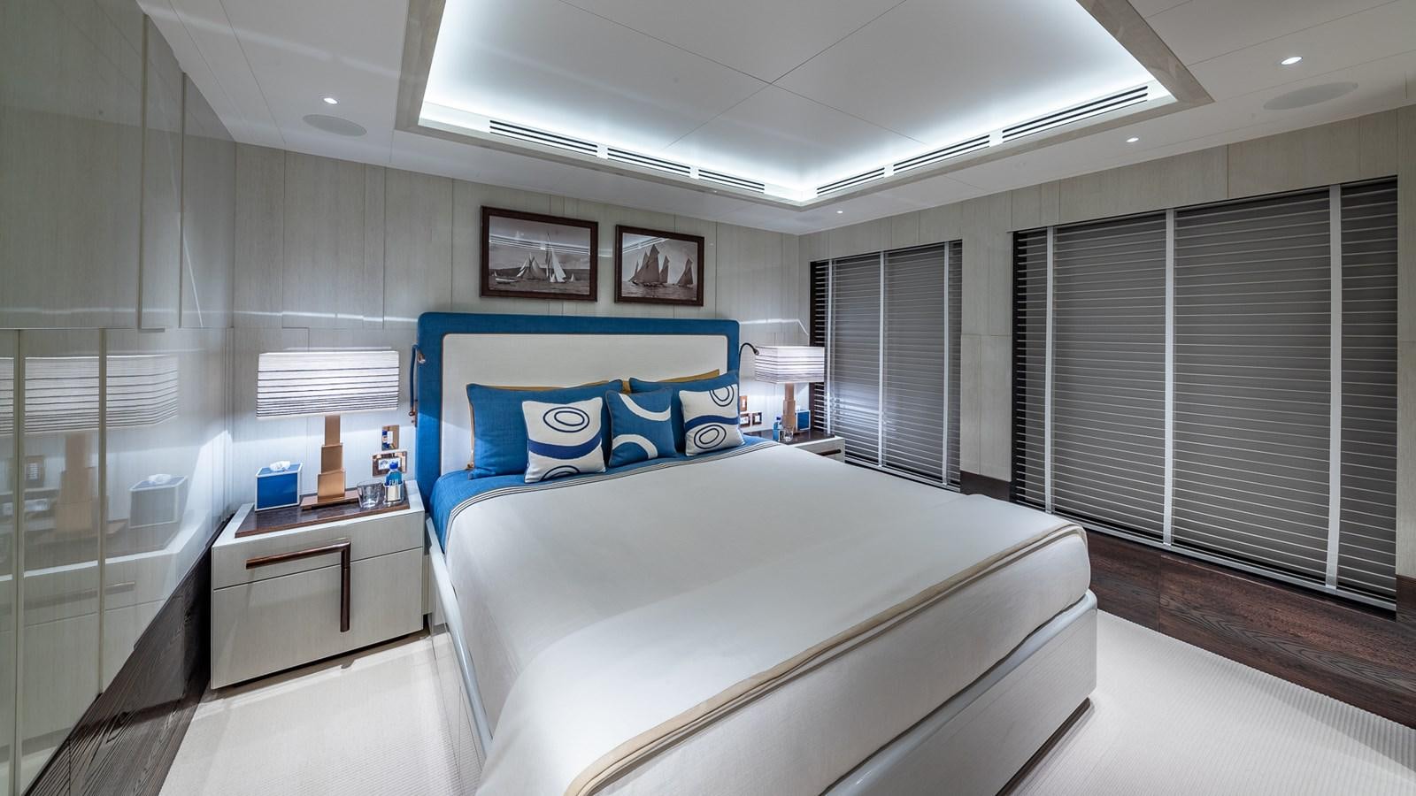 a bedroom with a bed and a desk aboard CC-SUMMER Yacht for Sale