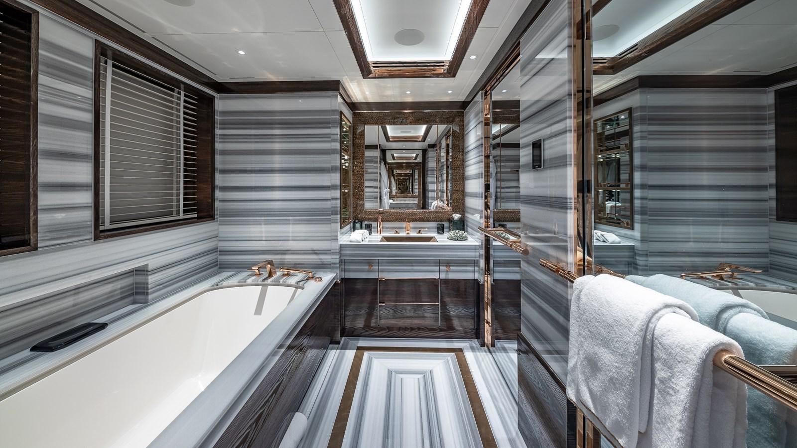 a bathroom with a tub and shower aboard CC-SUMMER Yacht for Sale