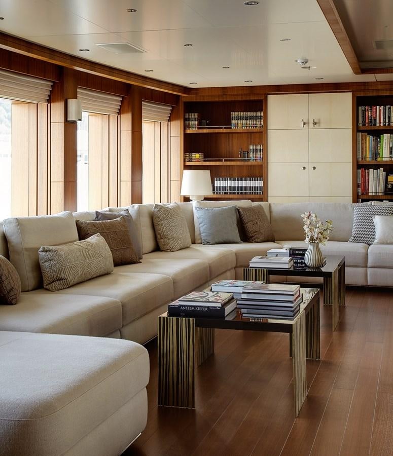 a living room with a couch and a coffee table aboard MAN OF STEEL Yacht for Sale