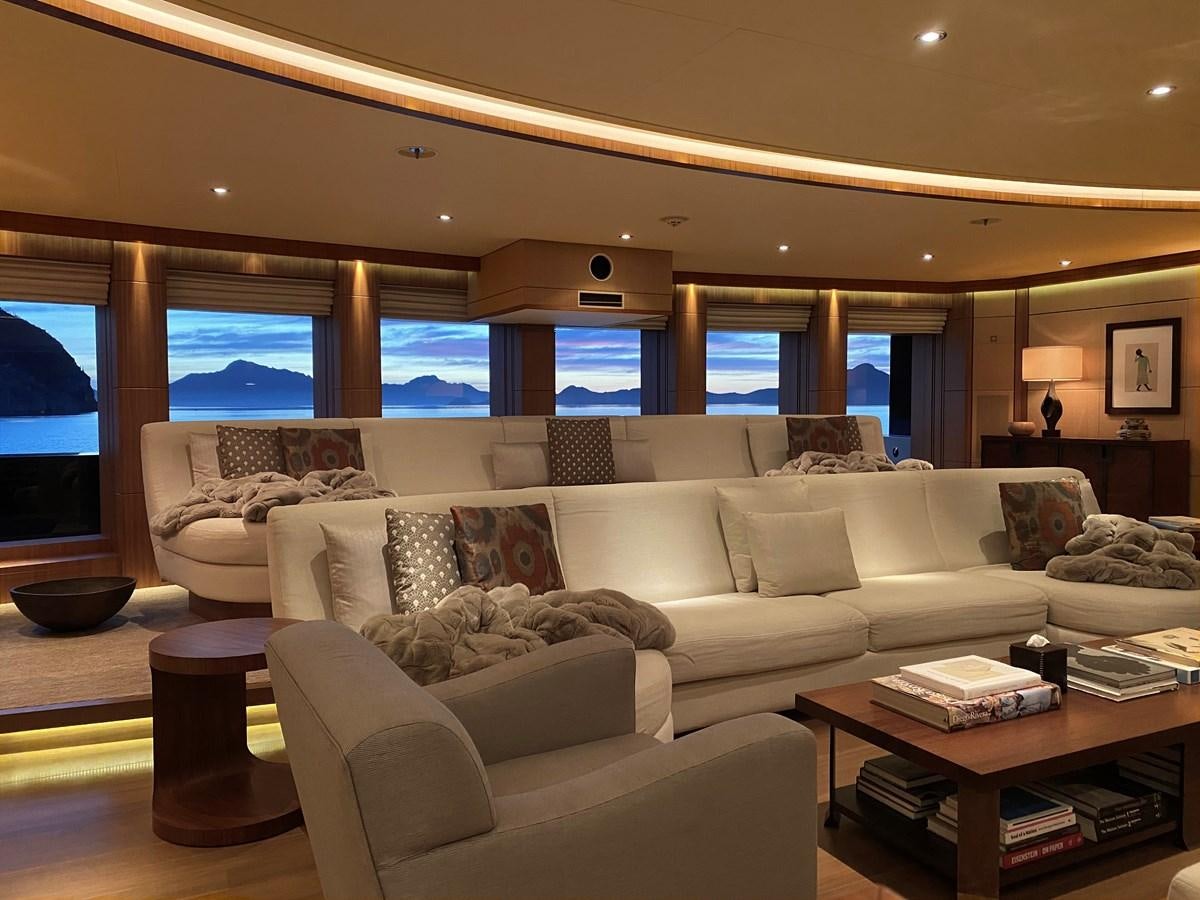 a living room with a large window aboard MAN OF STEEL Yacht for Sale
