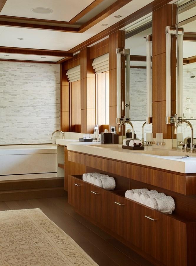 a bathroom with a large mirror aboard MAN OF STEEL Yacht for Sale