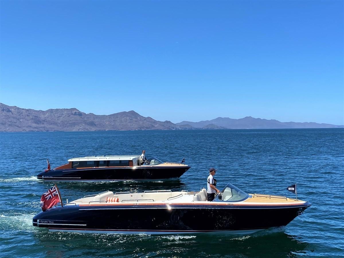 a person standing on a boat in the water aboard MAN OF STEEL Yacht for Sale