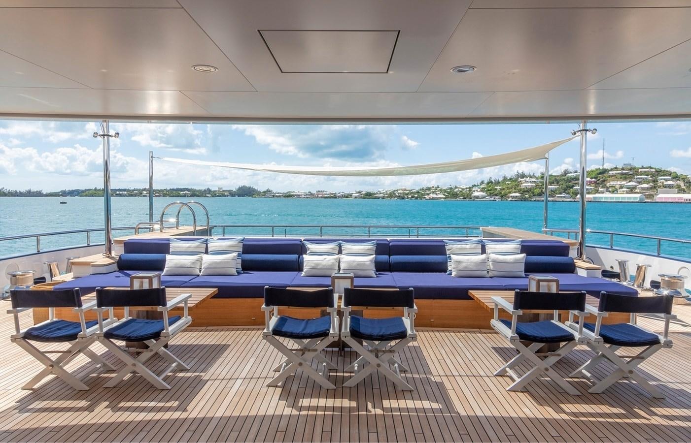 a pool with chairs and tables aboard HBC Yacht for Charter