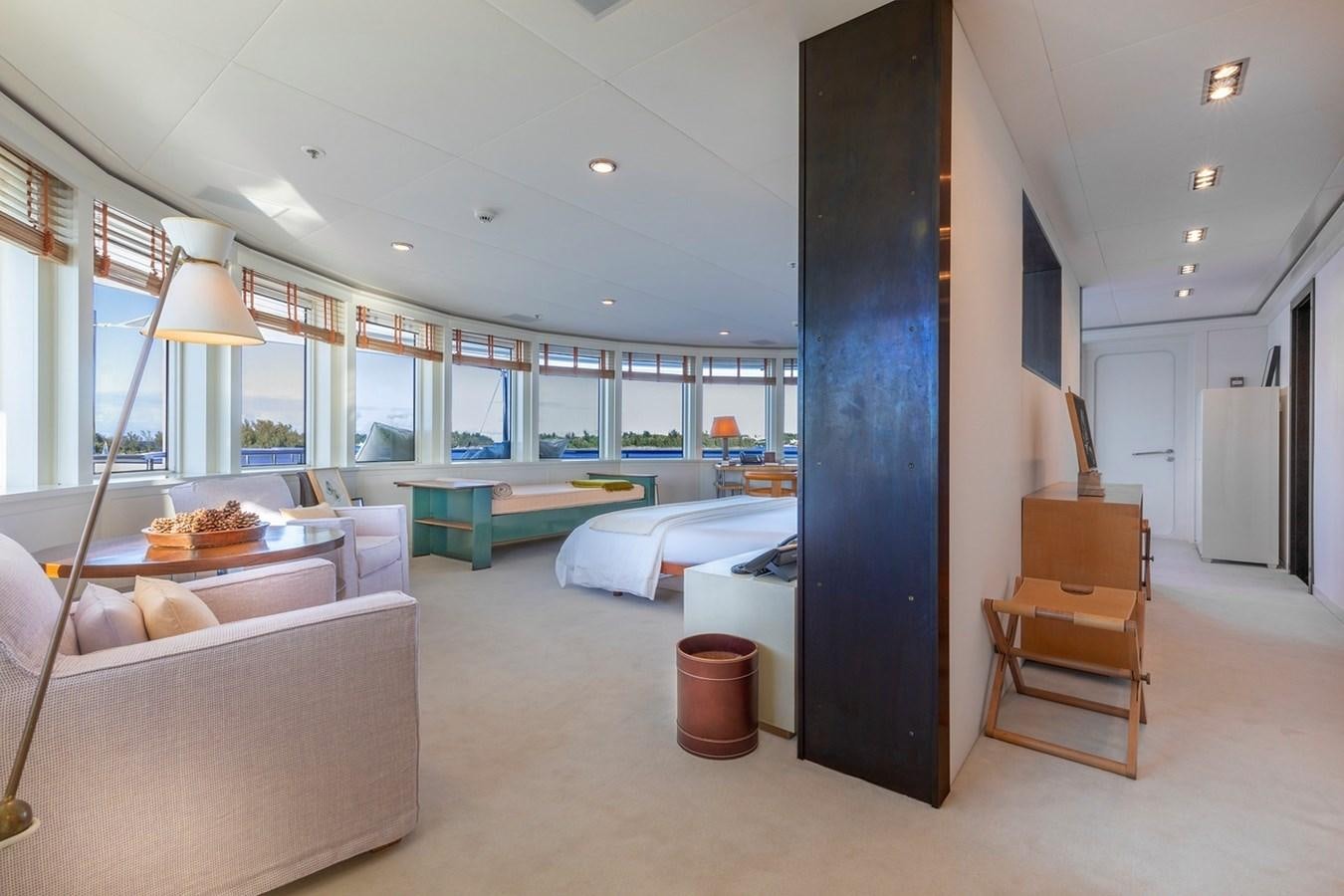 a room with a bed and a table aboard HBC Yacht for Charter