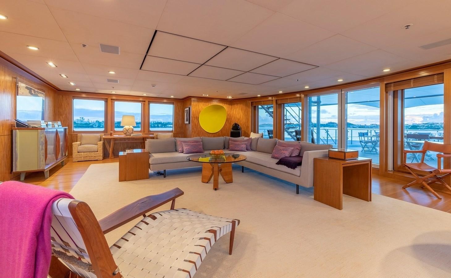 a large living room with a large window aboard HBC Yacht for Charter