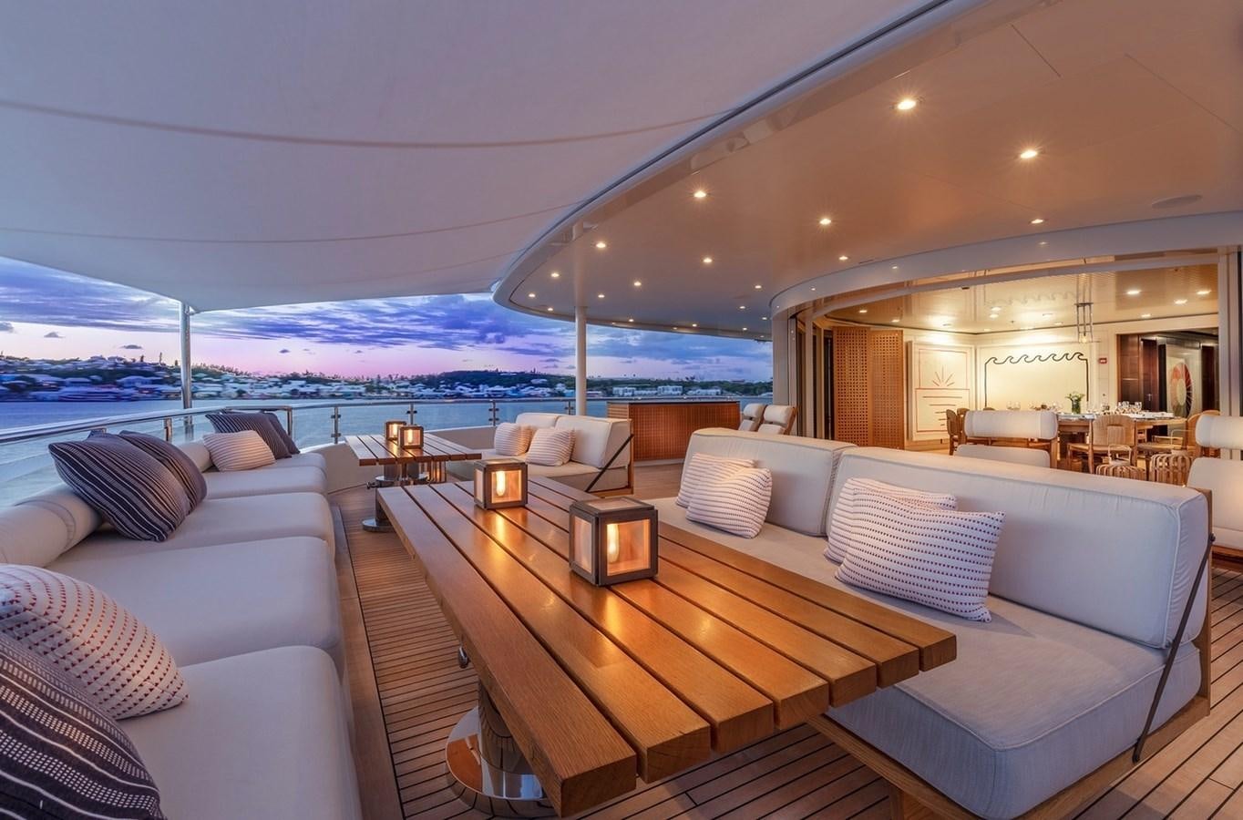 a large living room with a large balcony aboard HBC Yacht for Charter