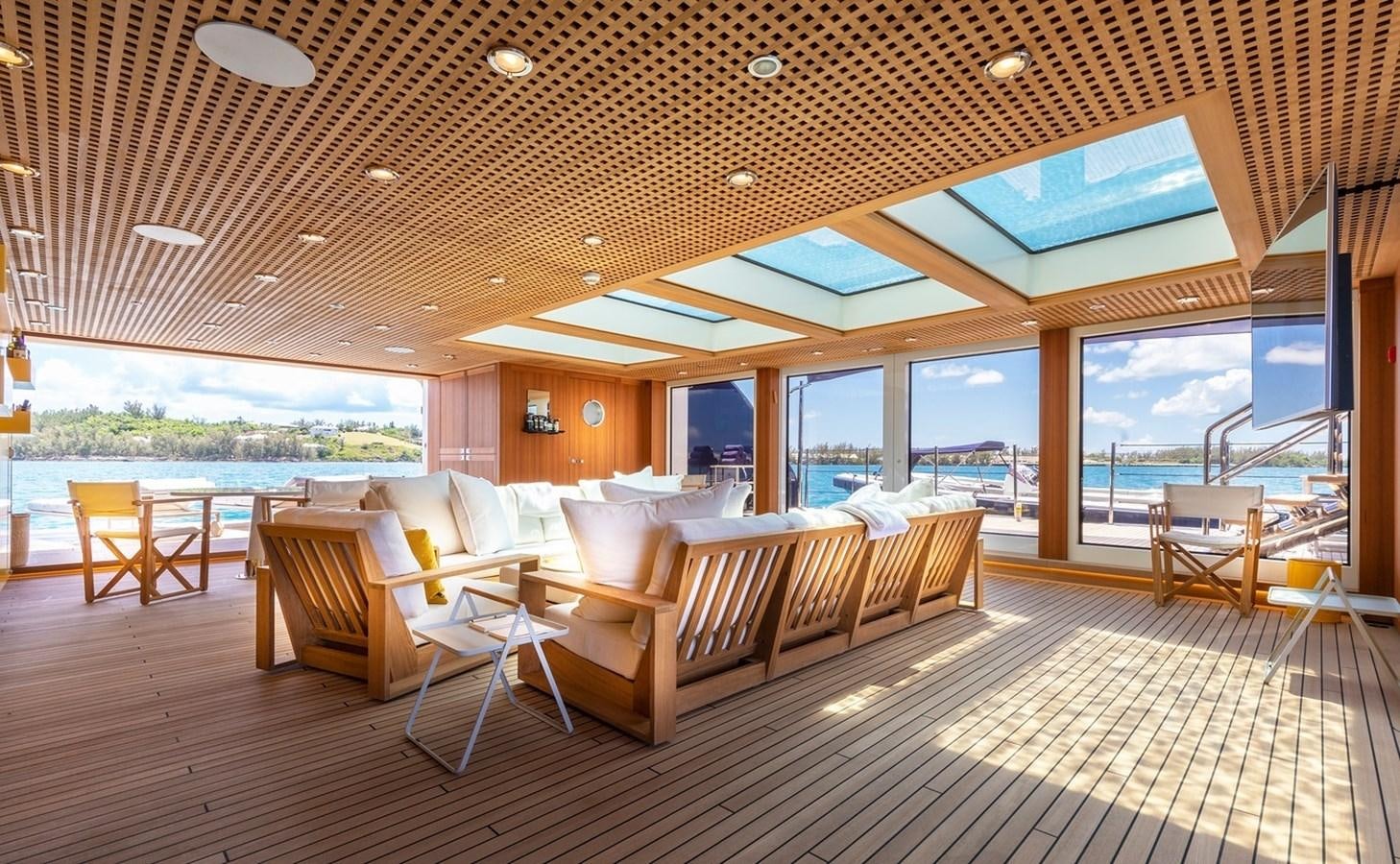 a room with a large window and a view of the water aboard HBC Yacht for Charter
