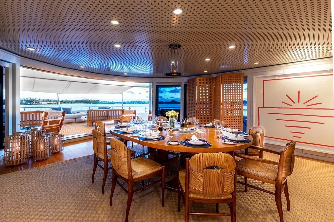 a dining room with tables and chairs aboard HBC Yacht for Charter