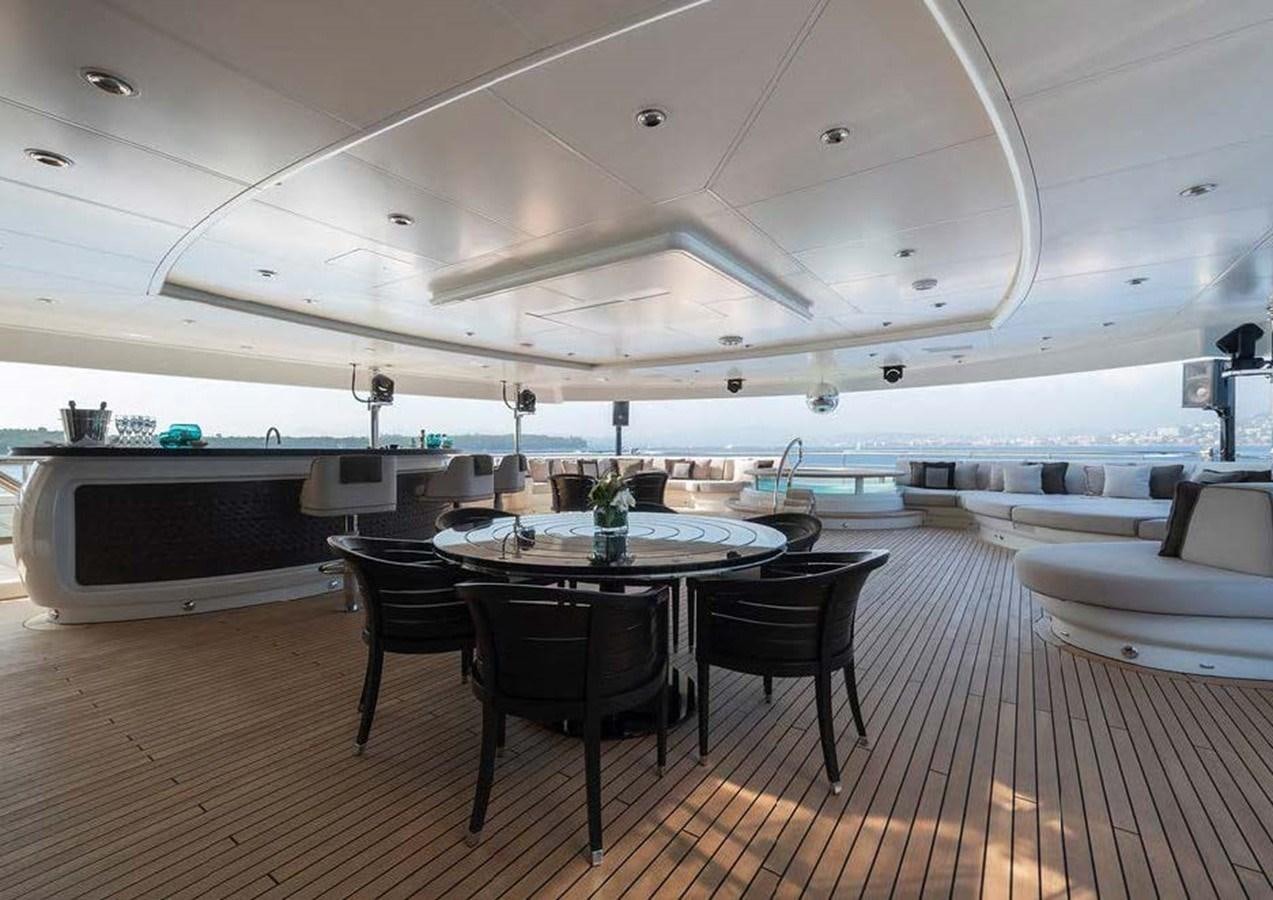 a large room with a table and chairs aboard SUNRAYS Yacht for Sale