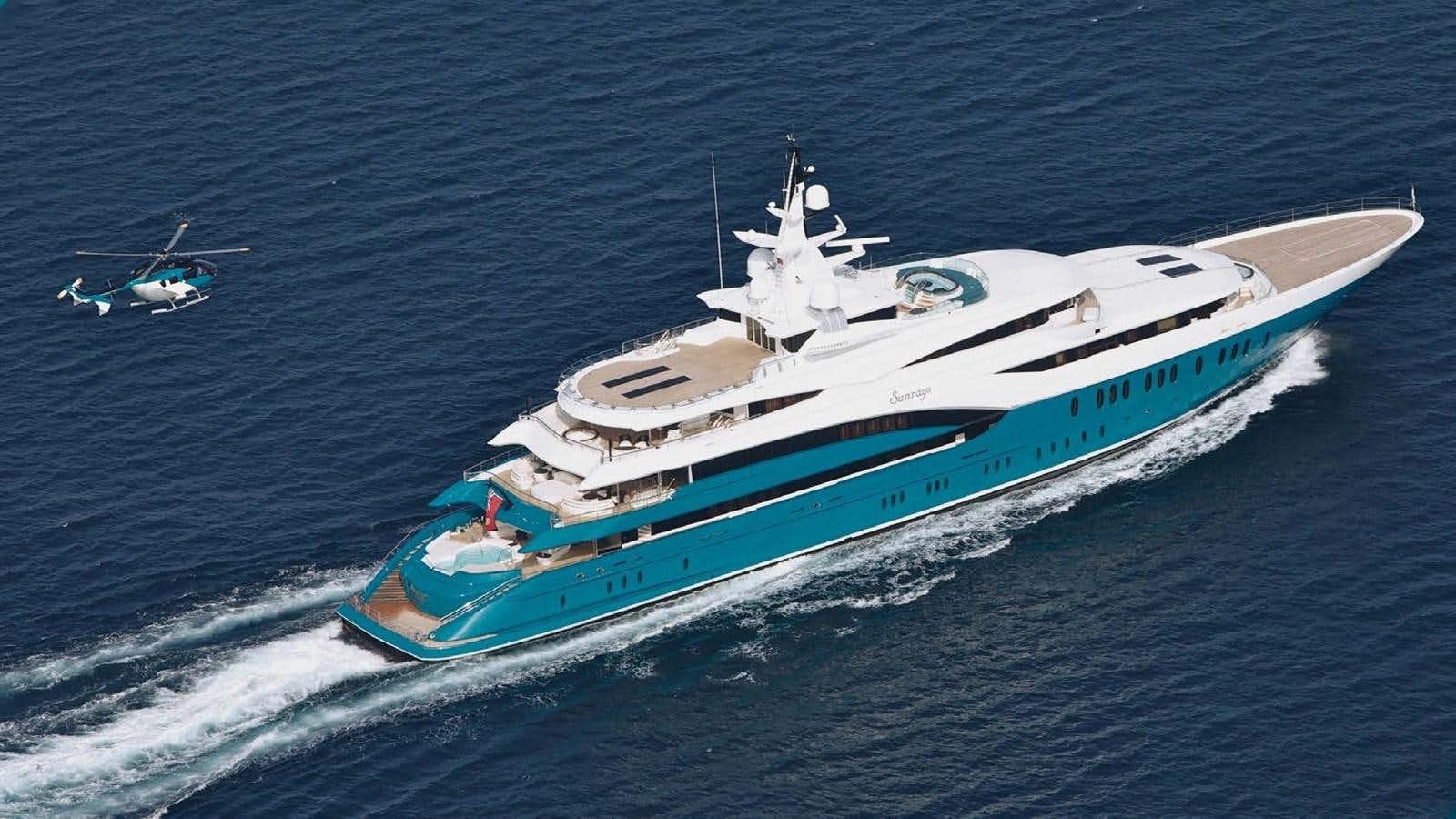 a boat with a helicopter flying over it aboard SUNRAYS Yacht for Sale