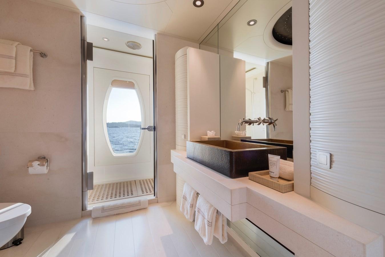 a bathroom with a tub sink and a mirror aboard SUNRAYS Yacht for Charter