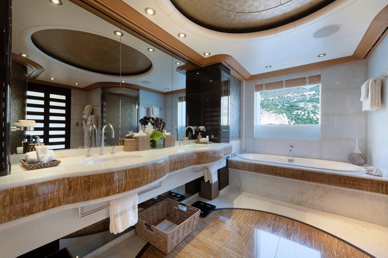 a large bathroom with a large mirror aboard SUNRAYS Yacht for Charter