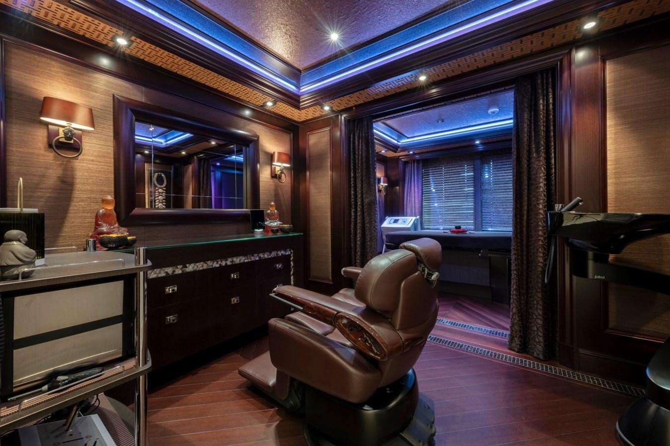 a room with a chair and a piano aboard EYE Yacht for Sale