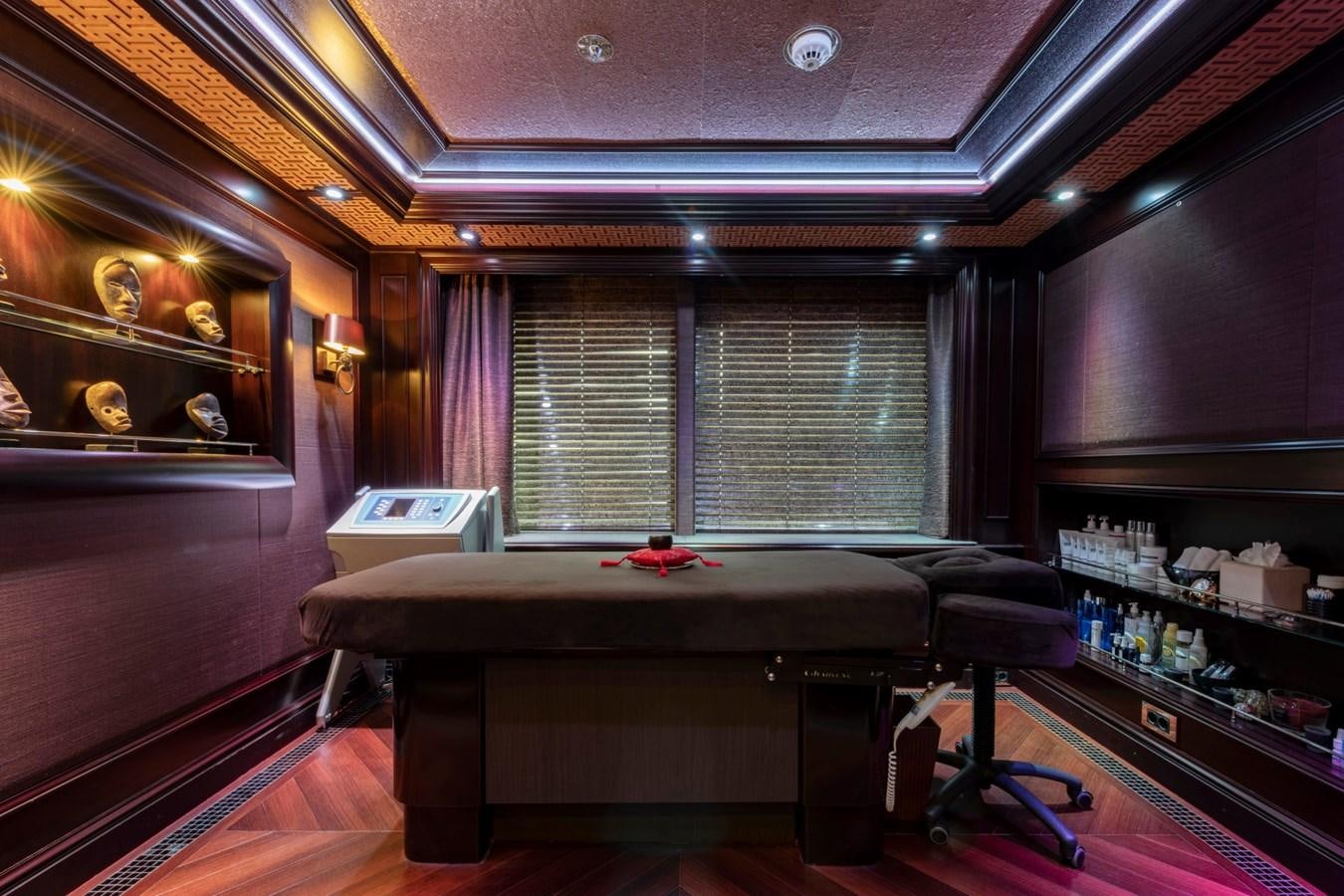 a room with a bar and a table aboard EYE Yacht for Sale