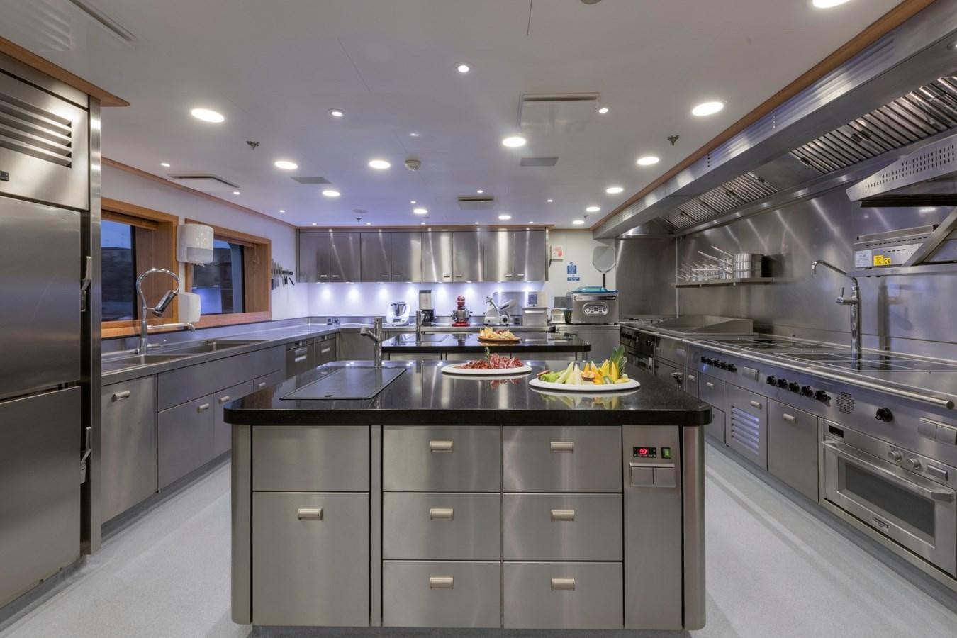 a kitchen with black counters aboard EYE Yacht for Sale