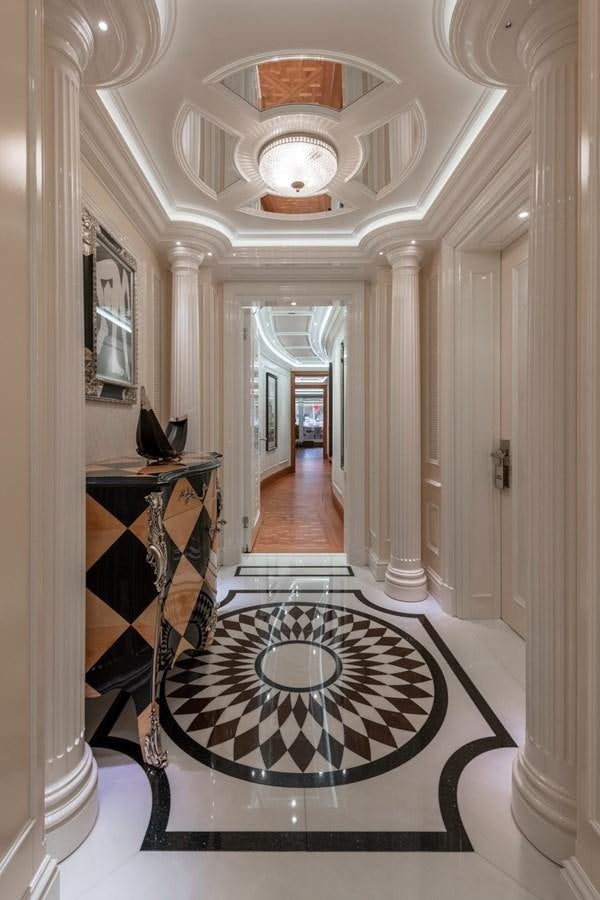 a hallway with a chandelier aboard EYE Yacht for Sale