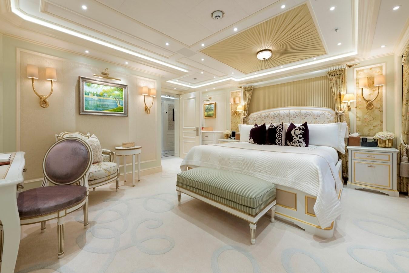 a bedroom with a bed and a chair aboard EYE Yacht for Sale