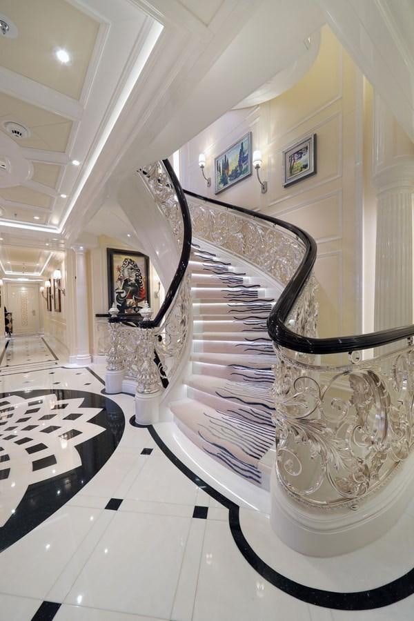 a large gold staircase in a room aboard EYE Yacht for Sale